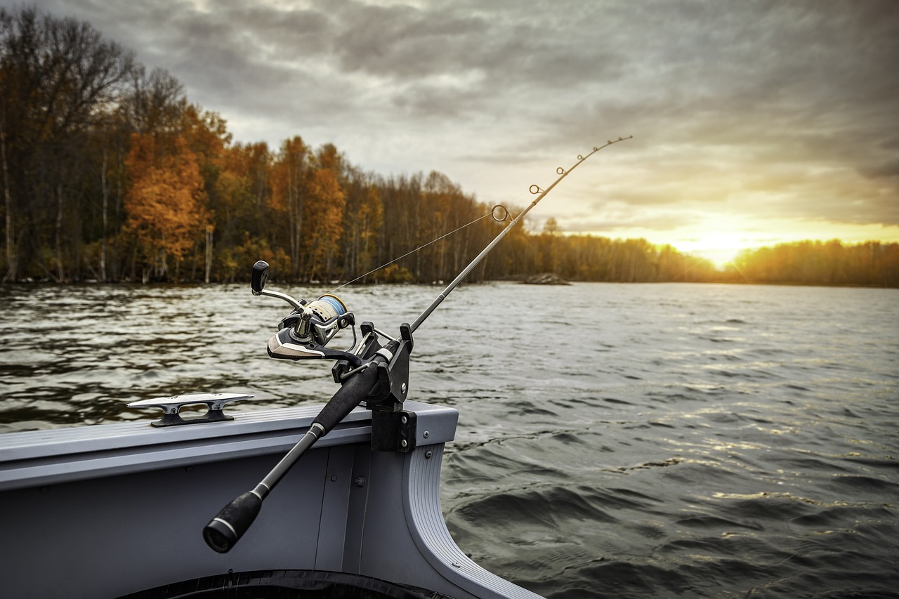 A boat with a line cast into the water on a lake