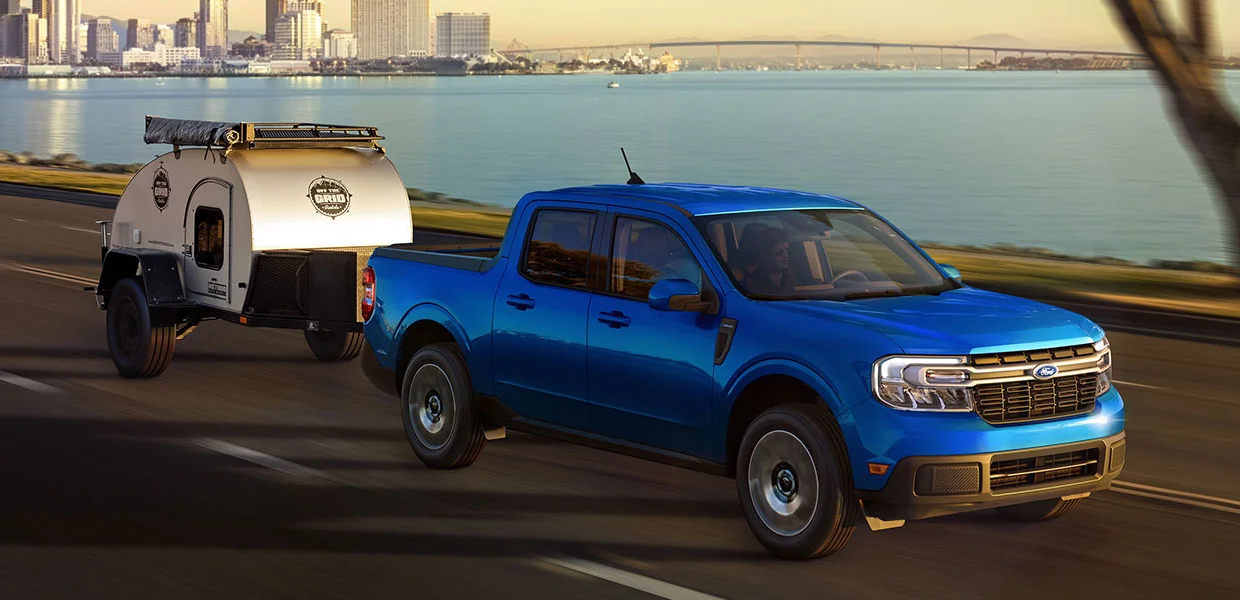 A Ford Maverick towing a small trailer