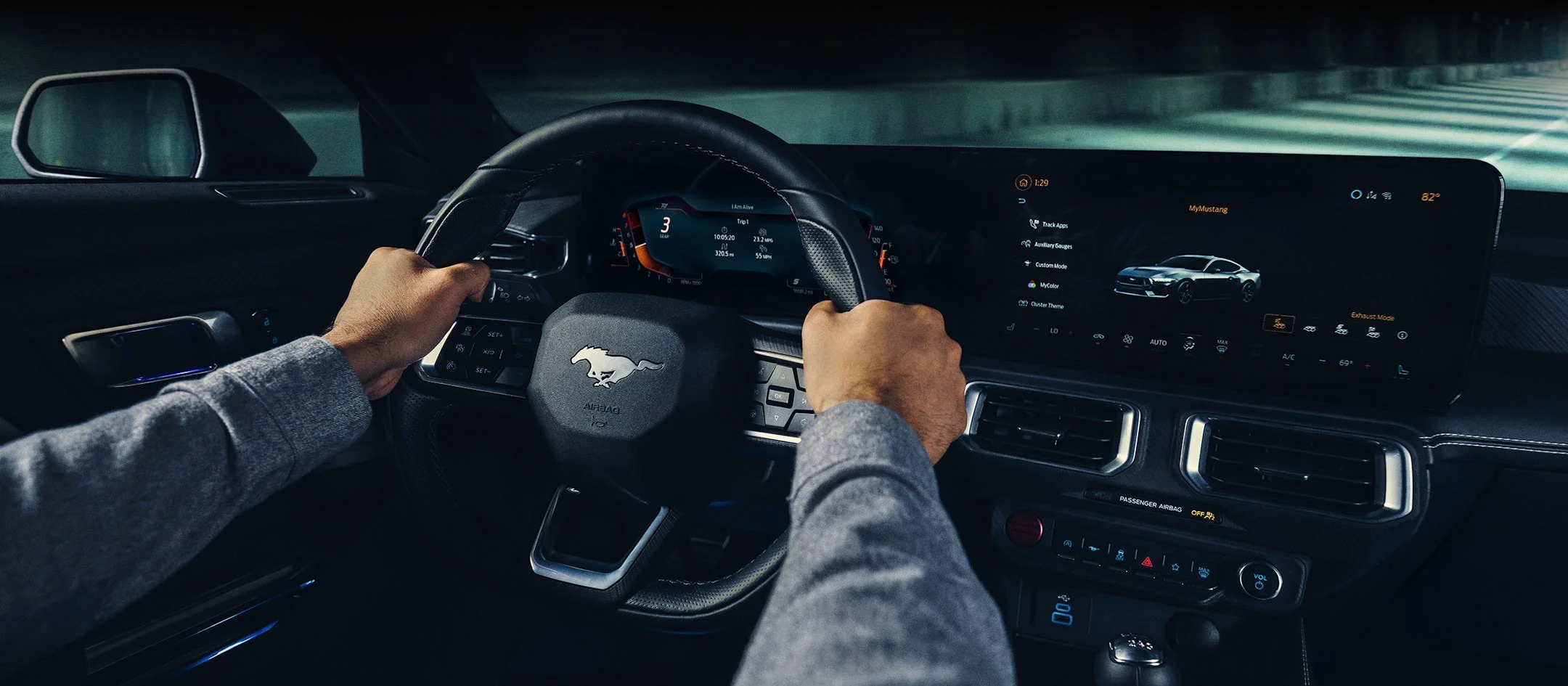 The interior steering wheel and dashboard of a 2024 Ford Mustang