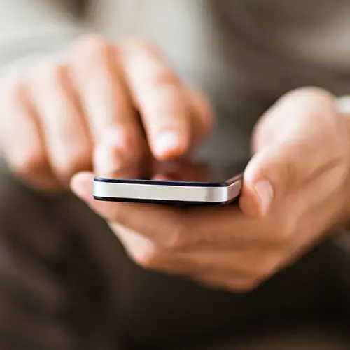 close up on hands handling a cellphone